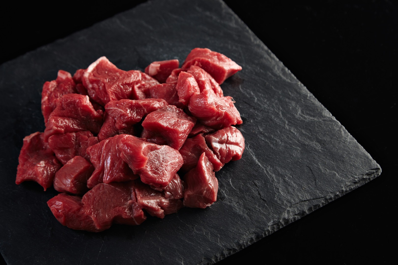 top-view-fresh-meat-slices-raw-meat-on-round-wooden-desk-on-dark-food-freshness-animal-cow-food-kitchen.jpg
