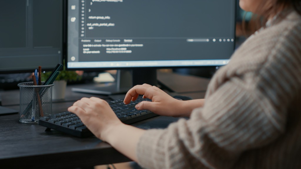 closeup-of-caucasian-software-coder-hands-typing-on-keyboard-in-front-of-computer-screens-with-programming-interface-database-developer-sitting-at-desk-writing-algorithm-for-it-agency.jpg