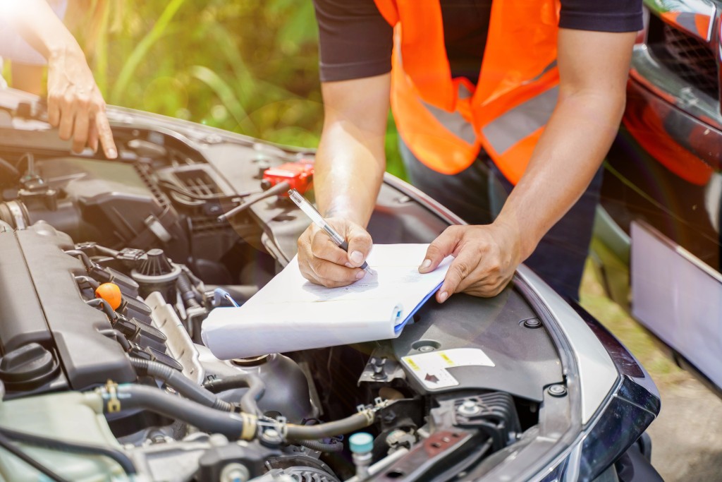 closeup-auto-repair-checking-engine-and-post-a-list-of-repairs-according-to-customer-orders.jpg