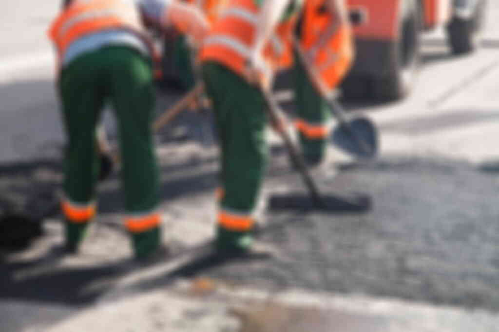 workers-on-asphalting-paver-machine-during-road-street-repairing-works.jpg